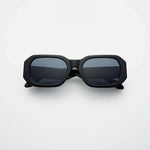 Black sunglasses with dark lenses on a white background