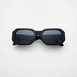 Black sunglasses with dark lenses on a white background