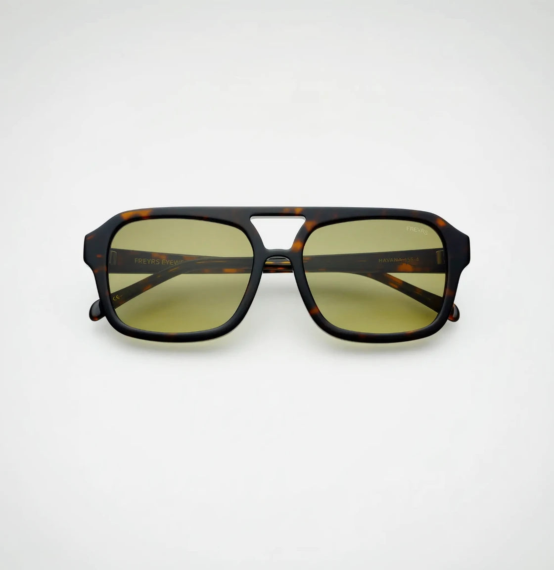 Sunglasses with tortoiseshell frame and yellow lenses on a white background