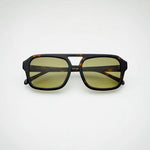 Sunglasses with tortoiseshell frame and yellow lenses on a white background