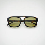 Sunglasses with tortoiseshell frame and yellow lenses on a white background